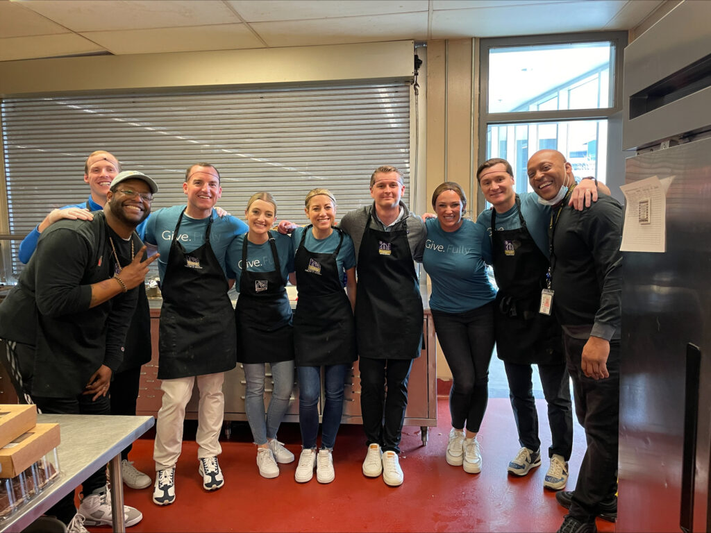 A group of ICS employees in an industrial kitchen