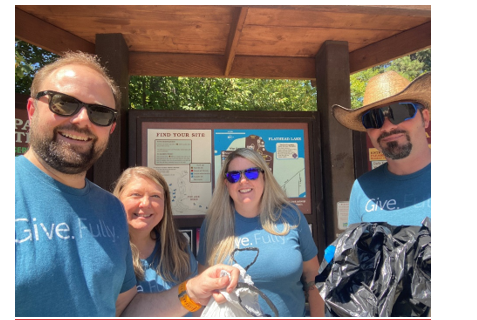 Four ICS employees smiling for a photo at a volunteer event.