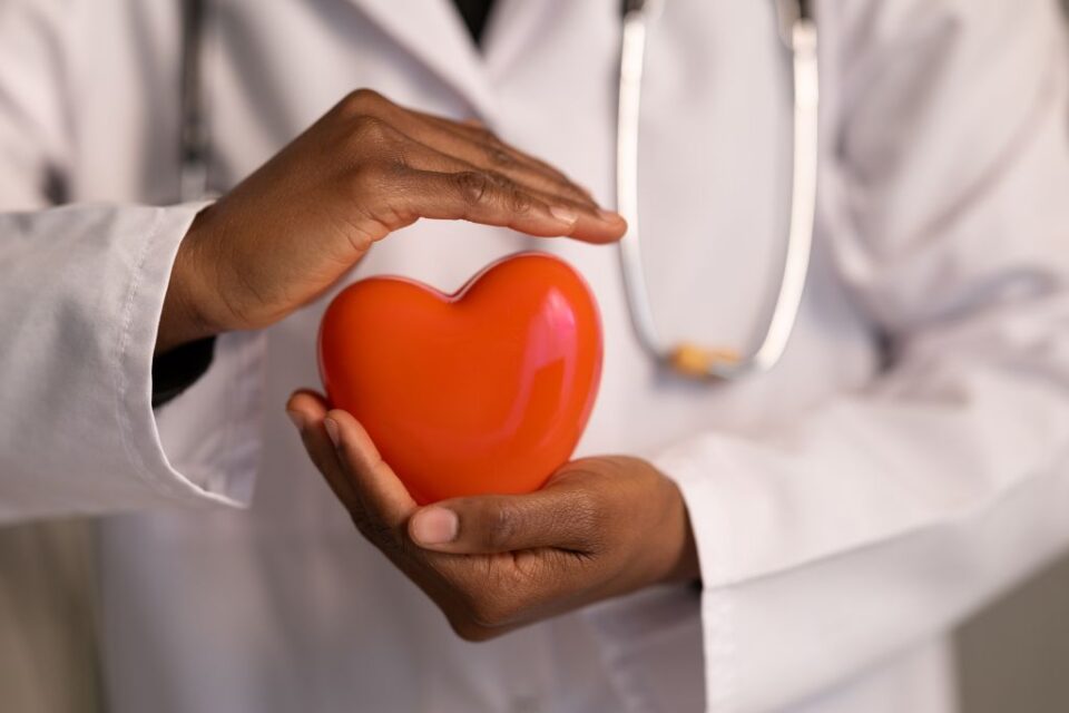 A doctor holding a cartoon heart